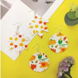 A yellow table with four different types of earrings.