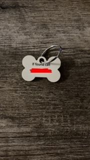 A dog tag that says if you 're in jail, it would call.