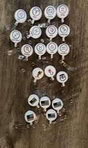 A bunch of different types of buttons on a wooden table