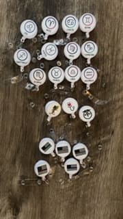 A bunch of different types of buttons on a wooden table