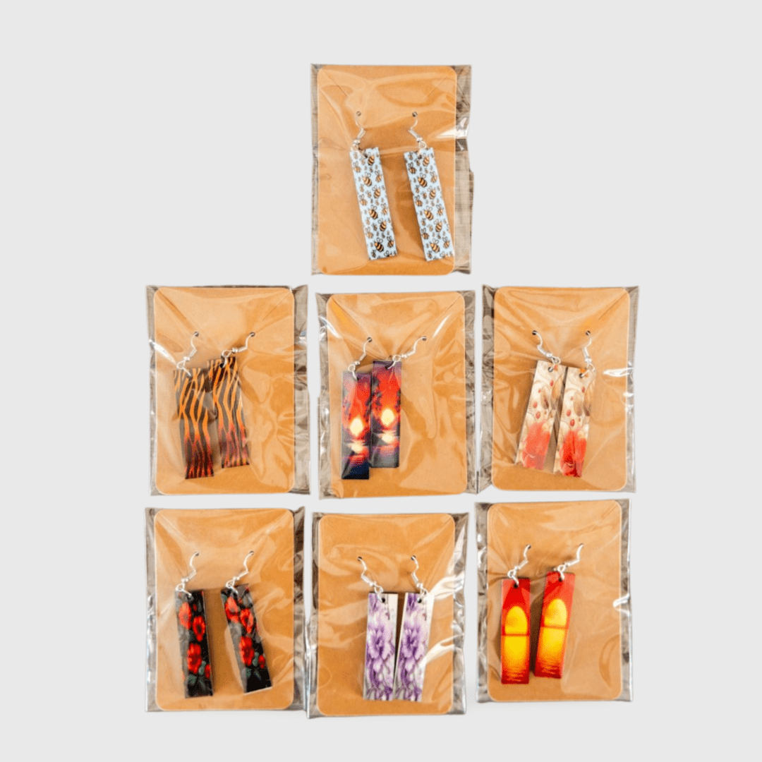 A group of eight pairs of earrings in plastic bags.