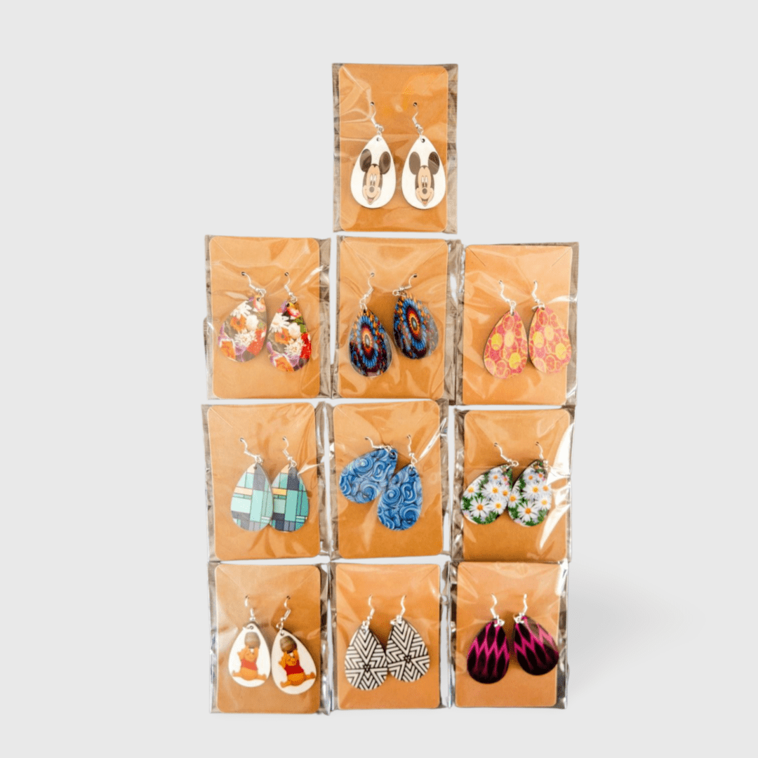 A pyramid of pairs of earrings in clear plastic.