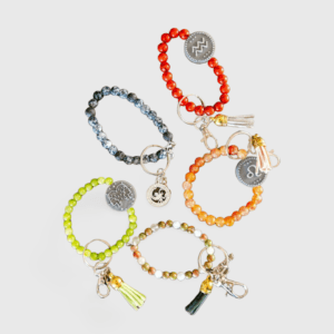 A group of bracelets with different colors and charms.