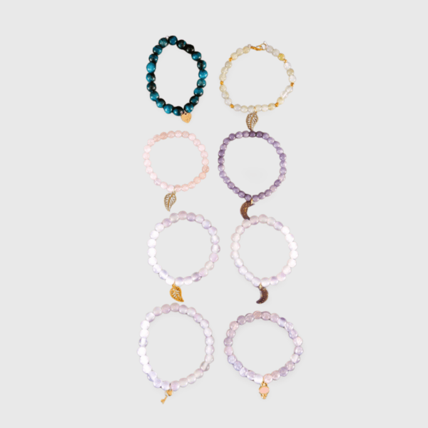 A set of eight bracelets with different colors and shapes.