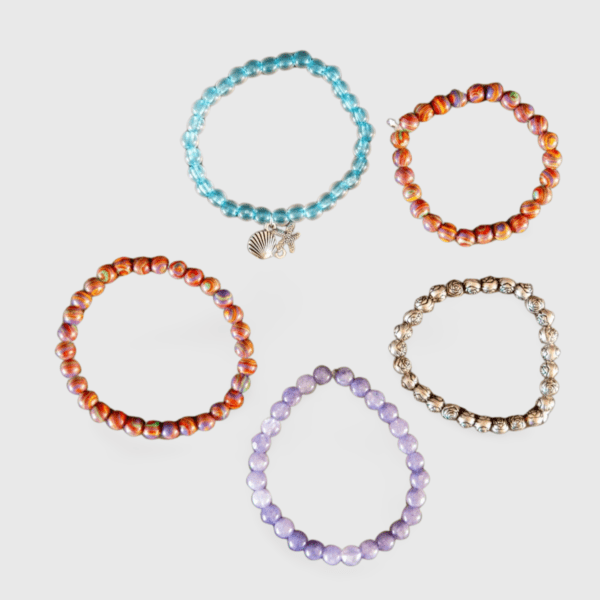 A group of bracelets that are sitting on the ground.