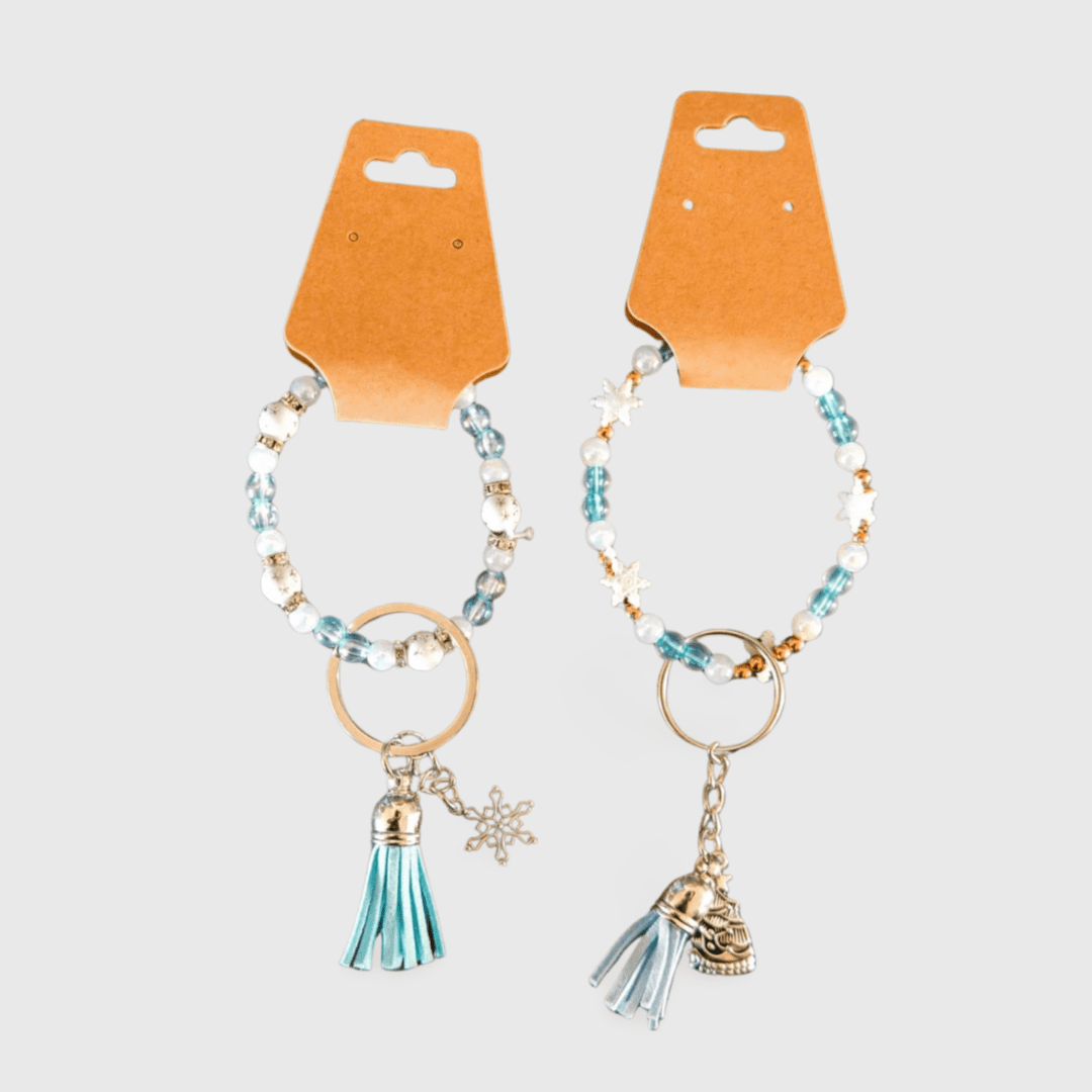 A pair of key chains with tassels and charms.