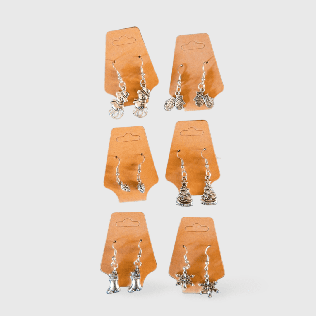 A set of six pairs of earrings on orange paper.