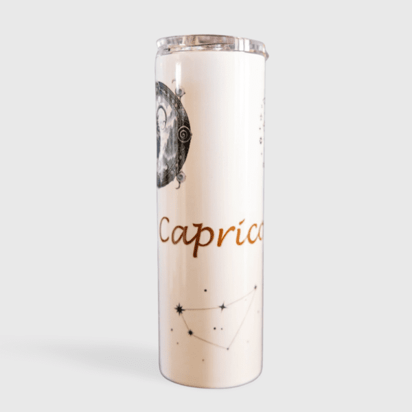 A tall candle with the zodiac sign capricorn on it.