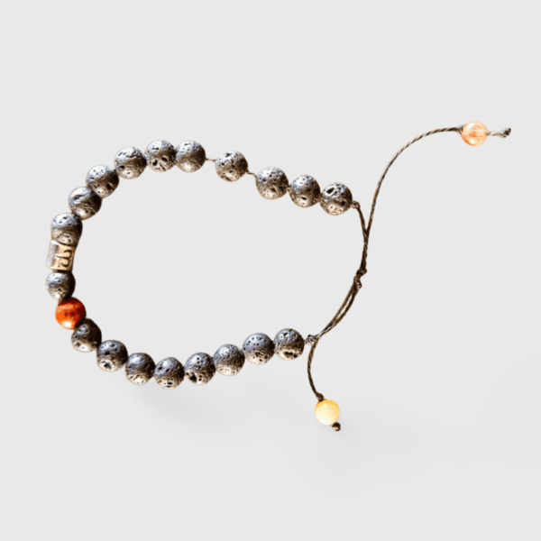 A string of beads with an orange bead on it.