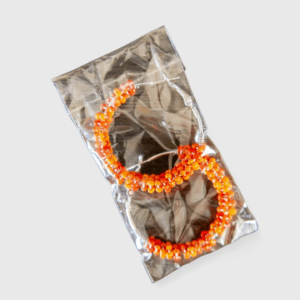 A pair of orange and yellow hair ties in a package.