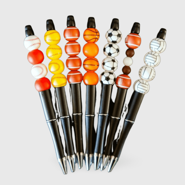 A group of pens with different colored balls on them.