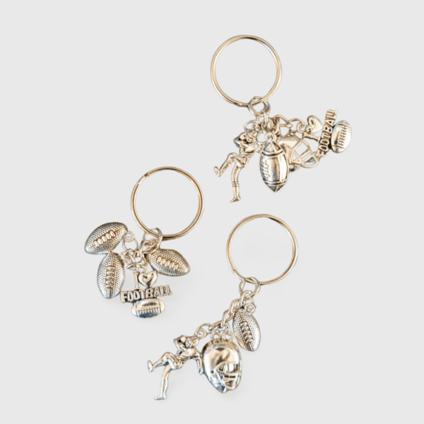 A set of three key chains with different charms.