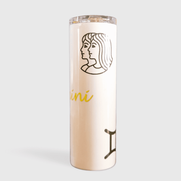 A tall candle with the zodiac sign gemini on it.