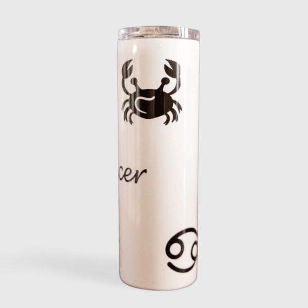 A white cup with black crab and zodiac symbols on it.