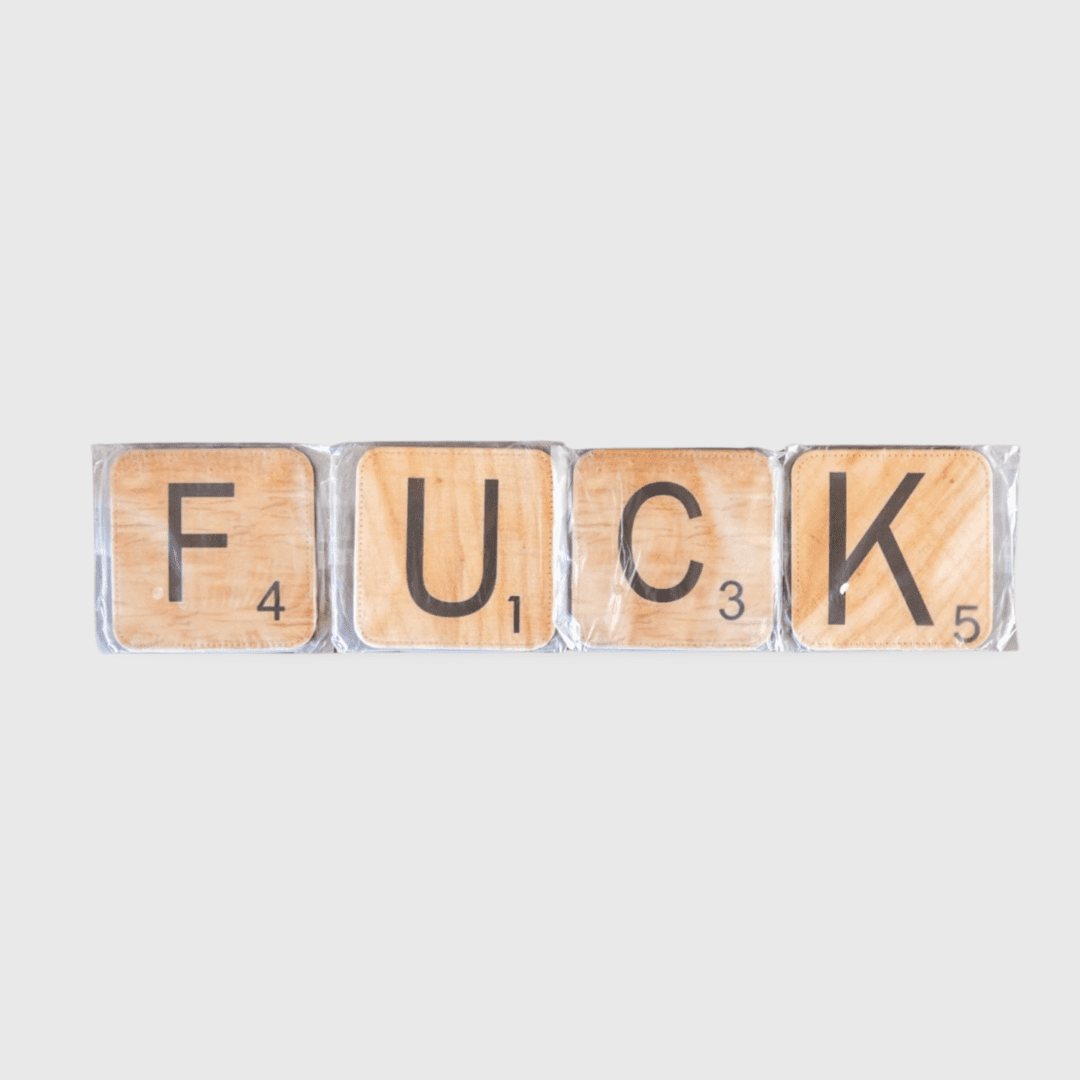 A word spelled out in scrabble tiles that spell " fuck ".