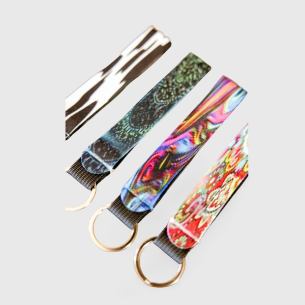 A group of four key chains with different designs.