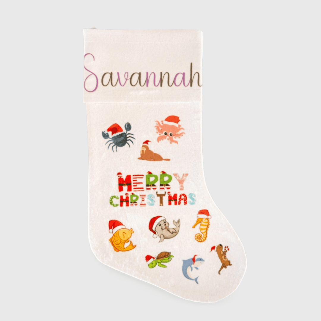 A white christmas stocking with various designs of animals.