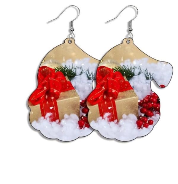 A pair of earrings with christmas decorations on them.