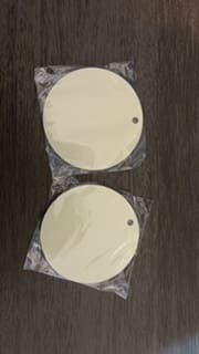 Two round white plates sitting on top of a table.