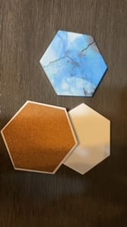 A table with three different colored coasters on it.