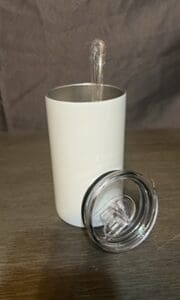 A white cup with a clear lid on top of a table.