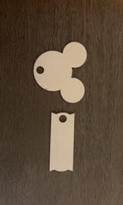 A white paper cut out of mickey mouse.