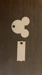 A white paper cut out of mickey mouse.