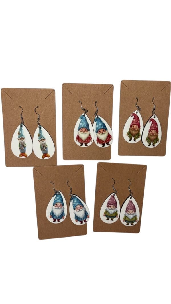 A set of five gnome earrings on brown paper.