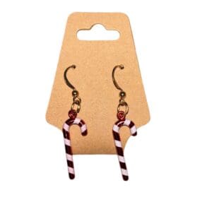 A pair of earrings hanging on a card.